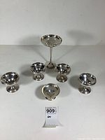 Photo of all six sterling silver bon bon dishes showing one tall footed Watson dish and five smaller bowls.