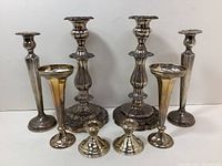 Front view of all eight candle holders arranged in four pairs