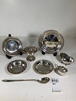Complete set of 8 sterling silver pieces including plates, bowls, sugar bowl, creamer, and spoon shown together.