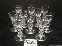Front view of all ten glasses arranged in rows showing overall quantity and design.
