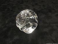 Front view of the clear crystal dragon hand warmer showing the curled dragon shape and detailed carving.