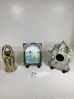 Three unique decor items shown together: Duxer vase, Gargoyles frog frame, sailing boat tile