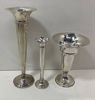 Three candle holders side by side against a white backdrop