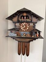 Close-up of clock face, balcony dancers and shingles