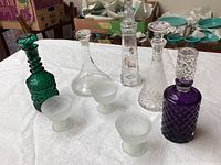 Overview of all five decanters and three frosted sherbet bowls