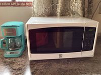 Photo showing the Kenmore 5 cup turquoise coffee maker alongside the white Kenmore microwave on a countertop.