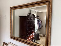 Front view of the large rectangular wall mirror showing the reflective surface and frame design.