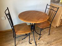 Front view of round table and two chairs