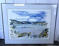 Framed watercolour painting showing full framed artwork with landscape and sailboats under cloudy blue sky