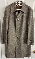Front view of grayish-brown textured wool long coat with collar and button closure.