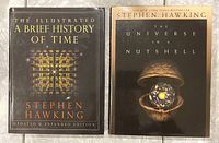 Photo of two Stephen Hawking hardcover books, 'The Illustrated A Brief History of Time' and 'The Universe in a Nutshell,' showing front covers with titles and cover art.