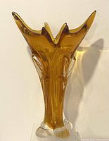 Front view of vintage amber Chalet art glass vase showing sculpted multi-pointed opening and clear base.