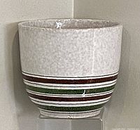 Front view of vintage Italian pottery planter showing pale gray upper half and multicolored horizontal bands on lower half.