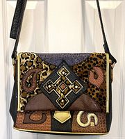 Front view of vintage NAS Korea shoulder bag showing multicoloured patch design with animal print and geometric embellishment