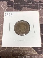 Obverse side of 1892 Indian Head penny showing the Native American headdress profile and date.