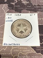 Obverse side of 1915 Cuba Silver 40 Centavos coin showing a star, date, and text details.