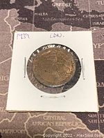 Reverse side showing symbolic figure and maple leaves with inscriptions on the 1939 Canadian Royal Couple Visit Token.