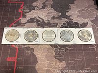 All five coins laid out showing both obverse and reverse sides