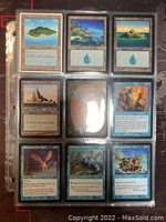 Nine Magic The Gathering cards displayed in a three-by-three grid in clear protective sleeve. Includes land cards (Island, Mountain), creature cards, and a spell card.