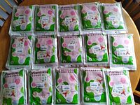 Photo showing 15 packs of Mamiu cut resistant latex gloves in size S, packaged individually in sealed green and white bags with pink circles.