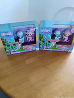 Two unopened boxes of Fingerlings Monkey Bar Playground Playset, showing front packaging and included monkeys inside.