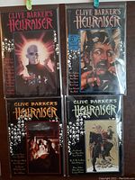 Four Hellraiser comic books hanging, showing cover art with horror themes and skull motifs, good condition