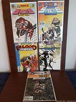 Photo showing five Blood Syndicate comic books from the 1990s by DC Comics, arranged in two rows with colorful cover art visible.