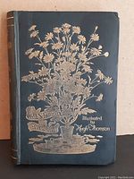 Front cover of 'Cranford' book featuring gold embossed floral design and title with illustrator's name.