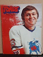 Front cover of the hockey program featuring a Toronto Toros player in white jersey number 23 with Toros and WHA logos.