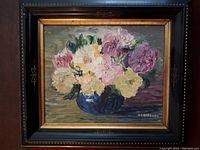 Front view of framed still life oil painting with flowers in blue vase.