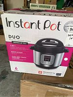 Front view of the original box showing Instant Pot Duo 7-in-1 pressure cooker branding, features, and 6-quart capacity.