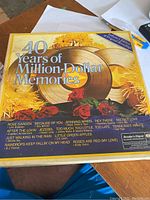 Photo of box with cover artwork listing song titles and set name