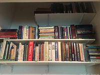 Bookshelves filled with various religious and reference books including Christianity topics, dictionaries, and handbooks.