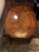 Top view showing burled wood surface with scratches and curved edges.