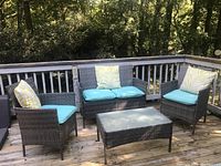 Full set on wooden deck: two single armchairs, loveseat, coffee table