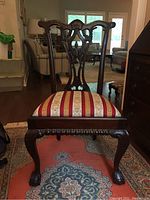 Front view of Queen Anne chair showing carved legs, seat, and backrest