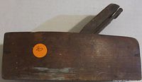 Top and side view showing the wooden body and metal blade assembly of the wooden block plane, orange sticker marked '90' visible