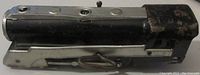 Top side view of the vintage Hafner wind-up engine toy showing black and silver paint with minor dents and wear.