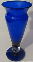 Full view of the blue glass vase showing its shape and color.