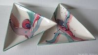 Top view of the double snack tray showing abstract hand-painted design with pink, blue, and purple swirls on white ceramic with green edges.