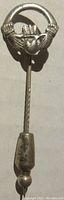 Full view of the sterling silver lapel pin showing the full 2 inch length and pointed end with safety cap.