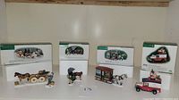 Four boxed Dept 56 New England Christmas collectible figurines displayed with boxes behind.