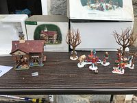 Wide view of the Cranberry House, Tapping The Maples figures, and trees arranged on a flat surface with packaging visible behind.