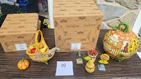 Full set of Jim Shore fall figurines displayed on a table with original boxes in the background.