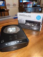 RCA Memory Maker device with Pandigital PhotoLink box in the background on wood table