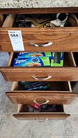 Four stacked wooden drawers partially open showing Ziploc bags and other items inside