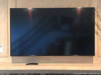 Full front view of the 50-inch Samsung TV mounted above a mantel