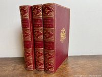 Three volumes at slight angle showing spines and front covers
