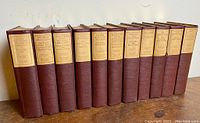 Full row of 11 volumes lined up side by side