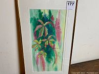 Full view of framed watercolor painting showing botanical leaves and abstract background.